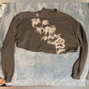 H&M gray crop top with “spray painted” phrase